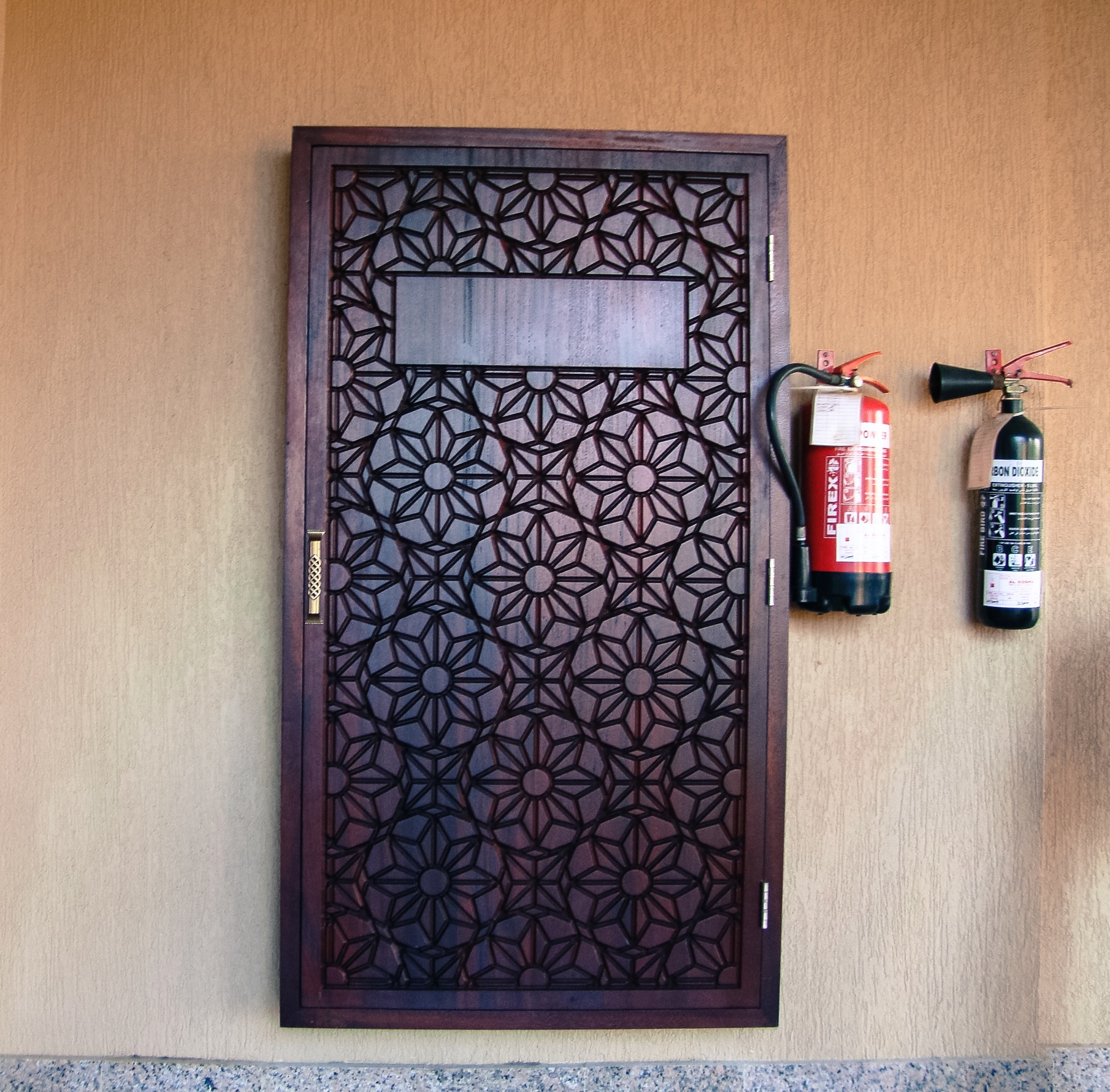Decorative CNC cut mashrabiya fire extinguisher cover with geometric pattern