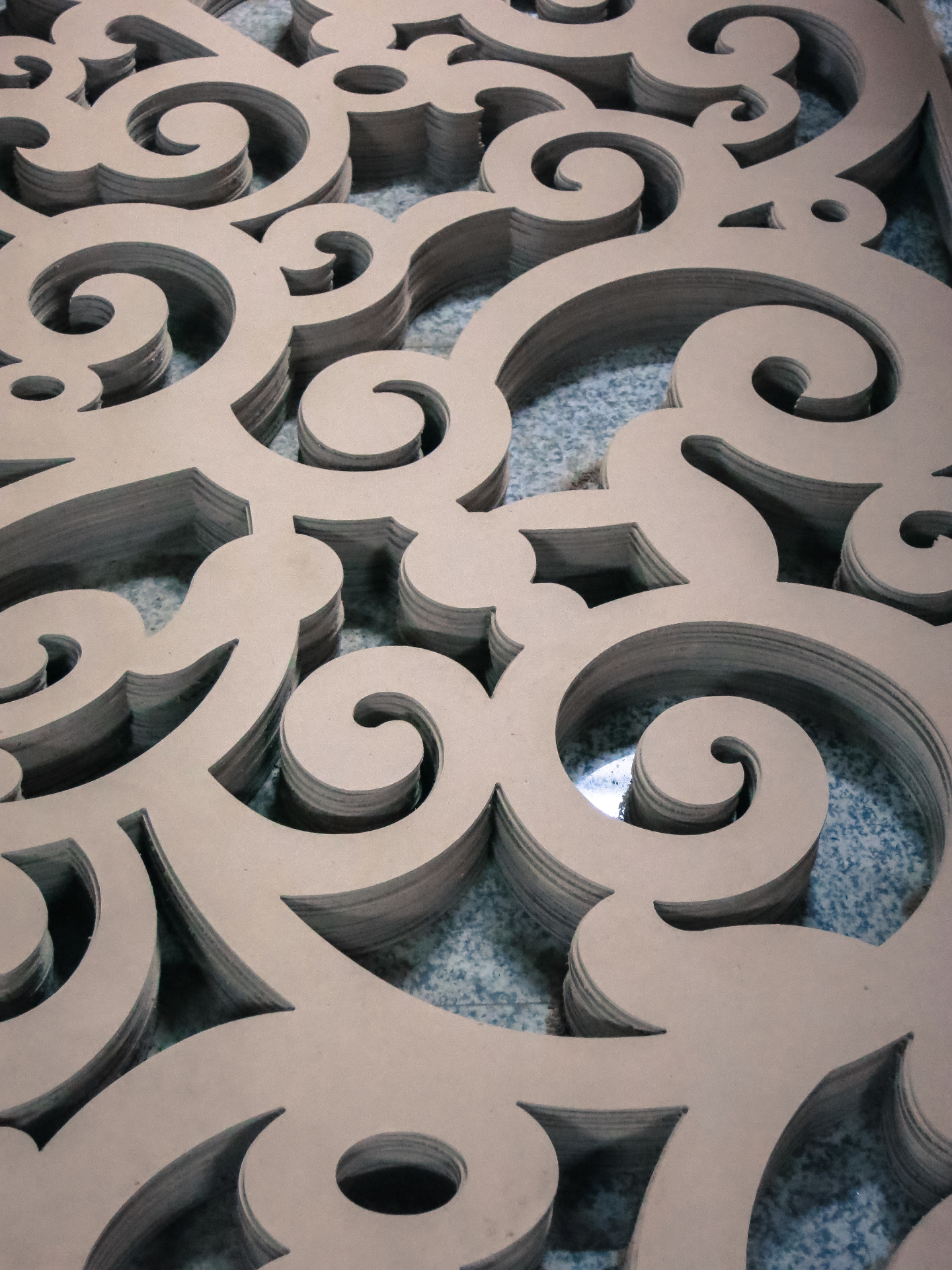 Precision CNC cut MDF scroll pattern panel showing intricate baroque curves